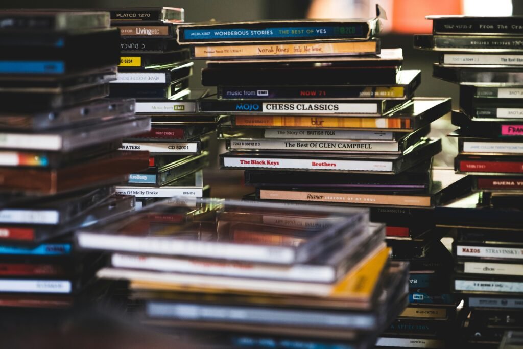 Stacked collection of music and audiobook CDs.